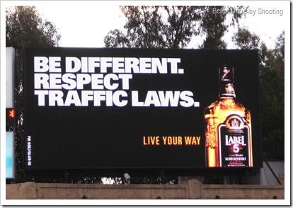 Billboard that reads: Be different, respect traffic laws
